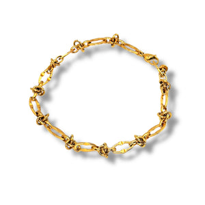 Gold chain bracelet on a white background