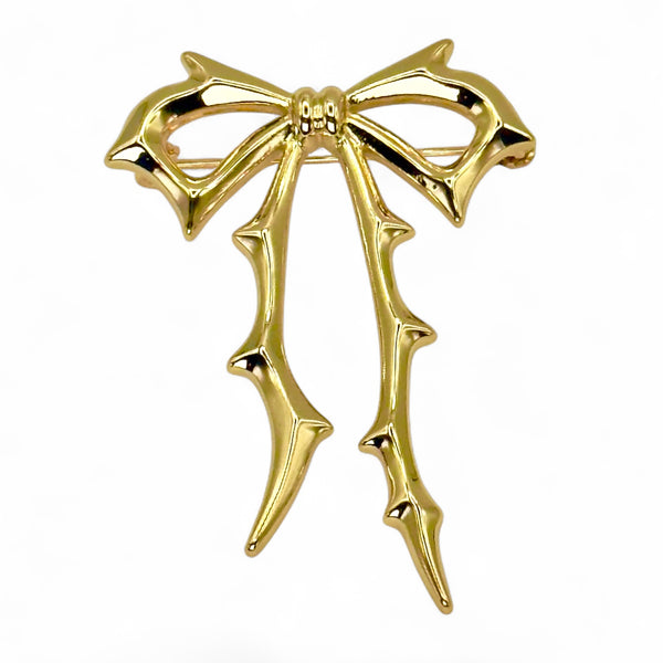 Carrie Bow Brooch in yellow gold with stainless-steel base and gold-filled bow design by Jagged Halo Jewelry.