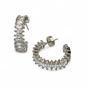 Silver hoop earrings with clear gemstones on a white background