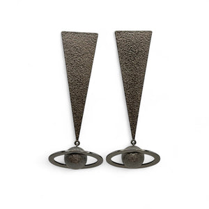 Pair of earrings with triangular designs on a white background