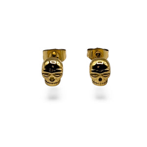 Gold skull-shaped earrings on a white background