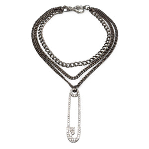 Stack of chain necklaces with a pendant on a white background