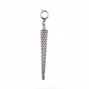 Silver charm with a textured design on a white background