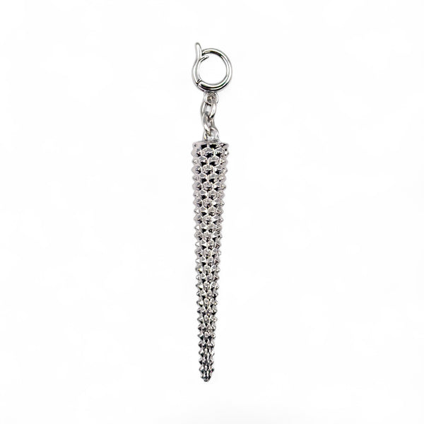 Silver charm with a textured design on a white background