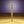 Gold textured pendant on a gold surface with a purple background