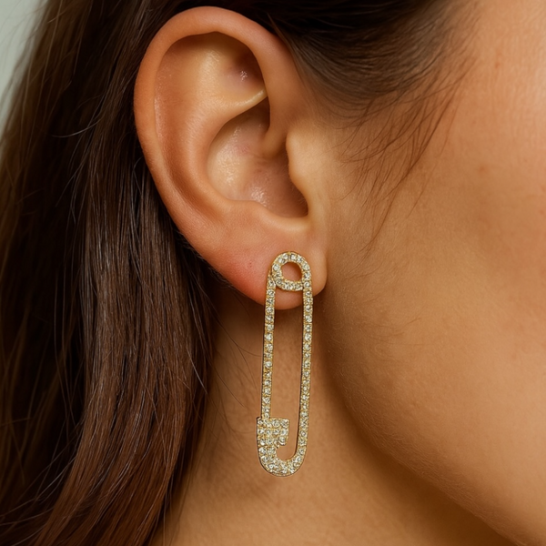 model wearing jagged halo jewelry ssfety pin earrings in yellow gold