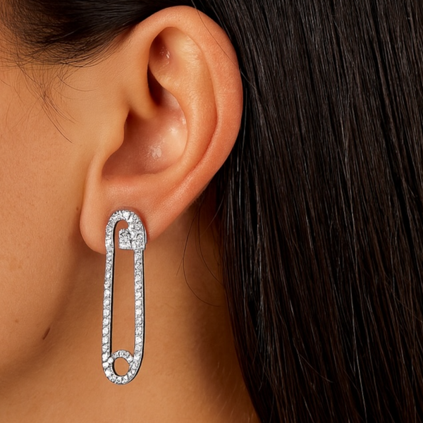model wearing safety pin earrings in white gold by jagged halo jewelry