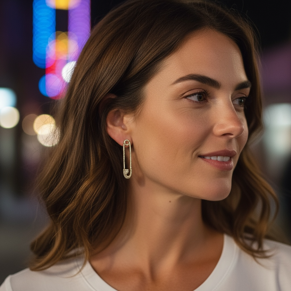 Woman wearing a gold earring with a blurred cityscape background