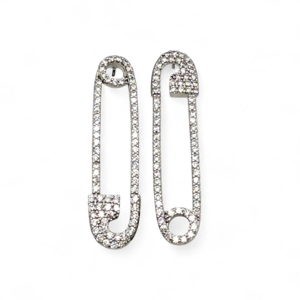 Pair of silver safety pin earrings with clear gemstones on a white background