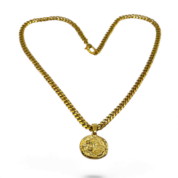 Gold chain necklace with a round pendant on a white background