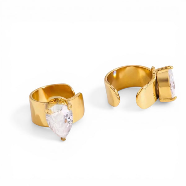 Gold hoop earrings with clear gemstones on a white background