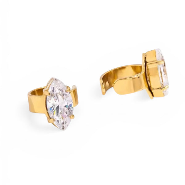 Gold hoop earrings with clear gemstones on a white background