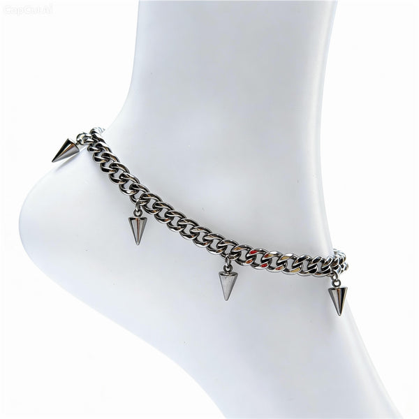 Silver chain anklet with pyramid-shaped spikes on a white mannequin foot.
