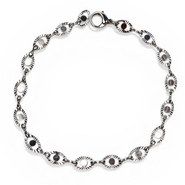 Silver bracelet with black stones on a white background