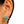 Gold star-shaped earring with turquoise stone worn by a person