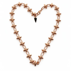 Rose gold barbie chain necklace with star-shaped spikes forming a heart shape on a white background by jagged halo jewelry 