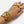 Hand wearing multiple gold bracelets and rings on a white background