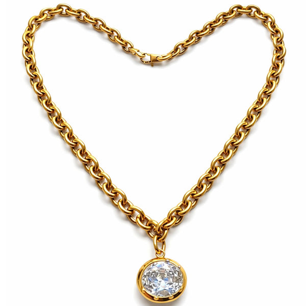 Gold chain necklace with a diamond pendant on a white background