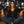 Woman sitting on a brown leather couch with a cityscape in the background
