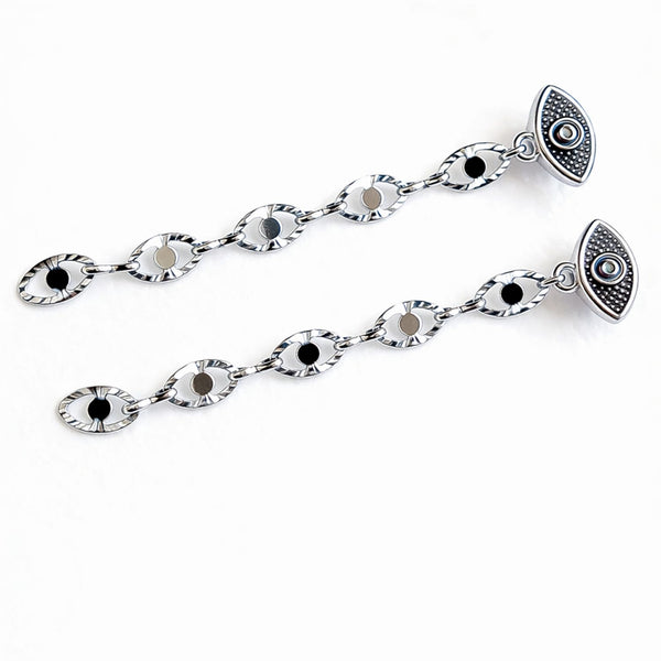 Silver chain with eye-shaped pendants on a white background