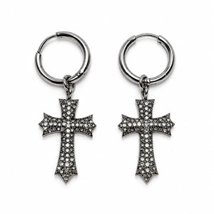 A pair of silver-toned hoop earrings with dangling cross charms, each adorned with small clear pavé stones, shown on a plain white background.