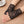Black lace  fingerless gloves on a person's hand with a cup of coffee in the background by jagged Halo jewelry 