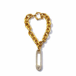Gold chain bracelet with a pendant on a white background