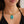 Gold necklace with a turquoise pendant worn by a person