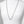 Silver chain necklace on a mannequin with a plain background