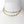 Gold chain necklace on a mannequin bust against a white background