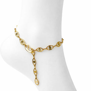 Gold chain bracelet on a mannequin arm against a white background