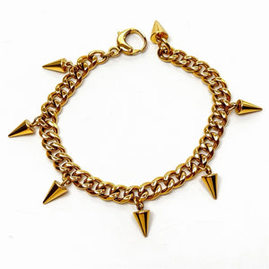 Gold chain bracelet with pyramid-shaped pendants on a white background