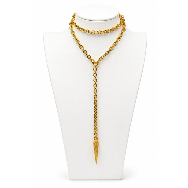 Gold chain necklace with a pendant on a white stand
