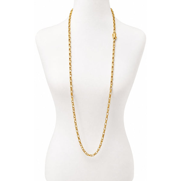 A gold chain necklace displayed on a white mannequin torso against a plain white background.