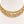 A three-layered gold chain necklace with textured and polished rectangular links, displayed on a white mannequin bust.