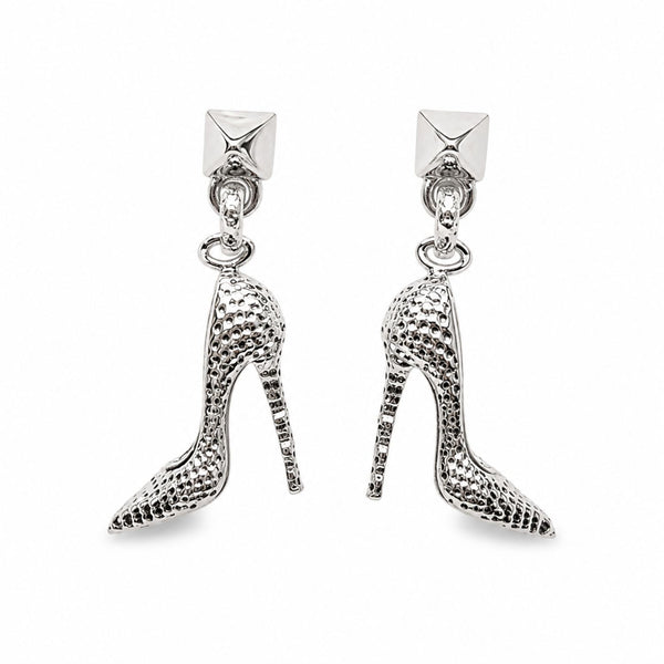 A pair of silver high-heeled shoe drop earrings with a textured, snakeskin-like pattern, featuring a small pyramid stud at the top.
