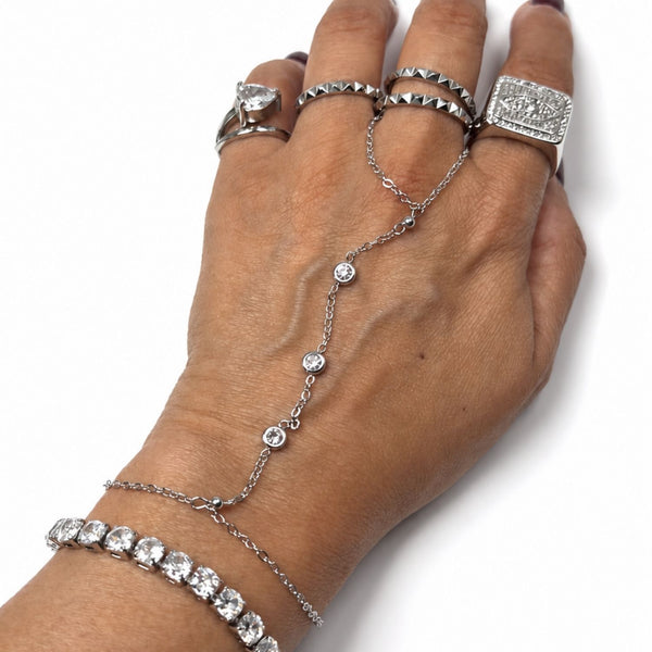 Silver Margot Crystal Hand Chain styled on a hand with rings and a tennis bracelet