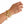 A gold-toned cuff bracelet with a raised eagle motif worn on a person's wrist, shown against a plain white background.