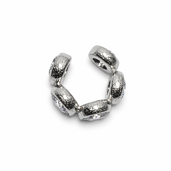 A silver-toned metal ear cuff featuring five textured, rounded segments with clear faceted rhinestones, shown on a plain white background.