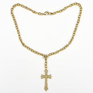 Gold chain necklace with a cross pendant on a white background yellow gold saints cross necklace by jagged halo jewelry