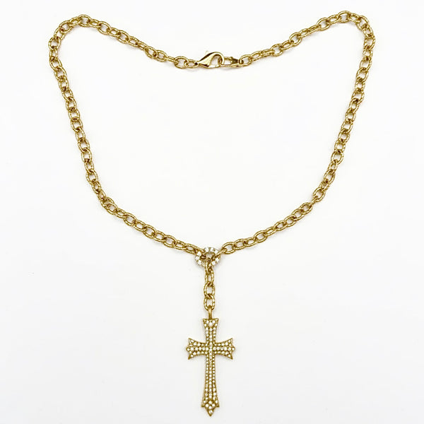Gold chain necklace with a cross pendant on a white background yellow gold saints cross necklace by jagged halo jewelry