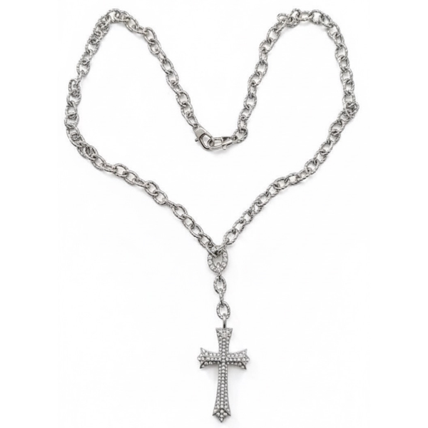Silver chain necklace with a cross pendant on a white background saints necklace by jagged halo jewelry