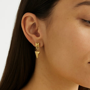 arrowhead drop earrings in yellow gold on a model