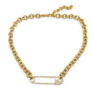 gold safety pin necklace on white background