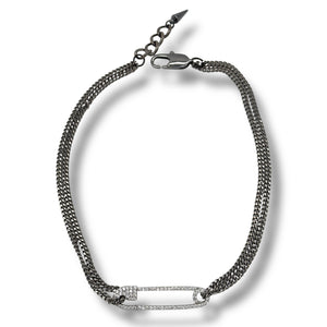 two-tone necklace gunmetal gray curb chain suspending micro pave set safety pin pendant. 